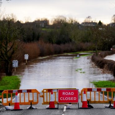 Severe flooding and snow disrupt travel as weather warnings remain