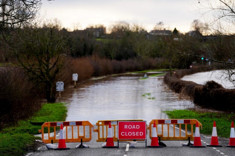 Severe flooding and snow disrupt travel as weather warnings remain