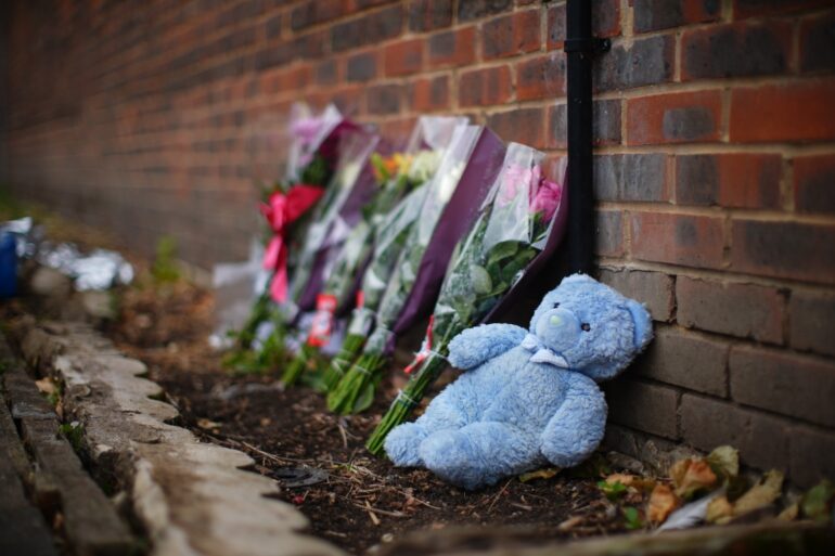 Floral tributes left at scene of house fire where mother and three children died