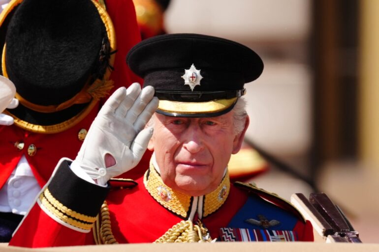 King wears black armband in memory of India air disaster at Trooping the Colour